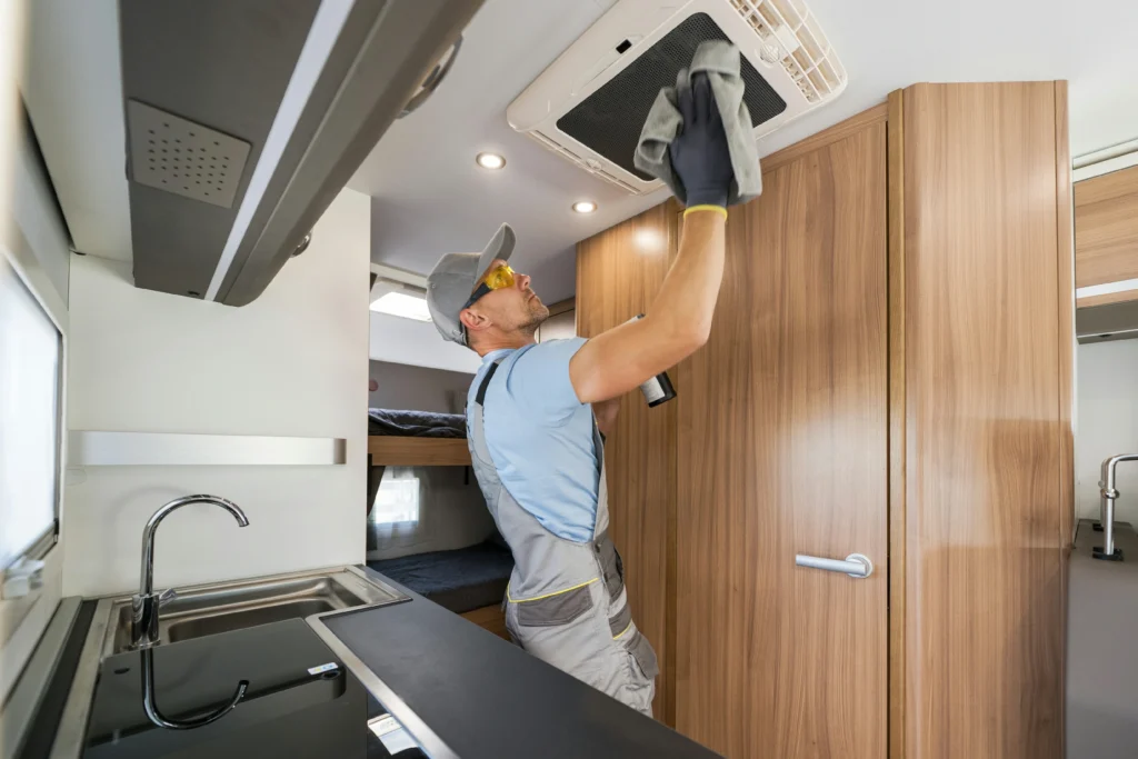 rv-rental-company-worker-cleaning-motorhome-air-co-2026-01-09-06-16-37-utc~1